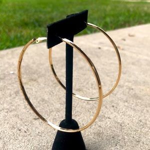 Oversized goldtone hoop earrings with clip on backs.